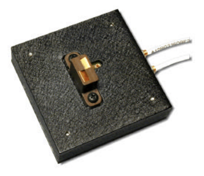 Small black square electronic module with a copper connector and two wires exiting the side.